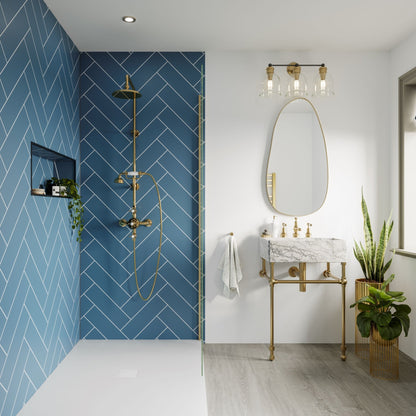 Multipanel Misty Blue Herringbone shower panels to match the gold and white bathroom. They use blue shower panels on the left hand side with the gold shower head and shower door to match the blue wall panels and having the mirror and sink on the left with the gold mirror lights and bathroom sink with plants down beside the sink and accessories with the main focus being the wall panels on the left-hand side - shower panels - The Wall Works