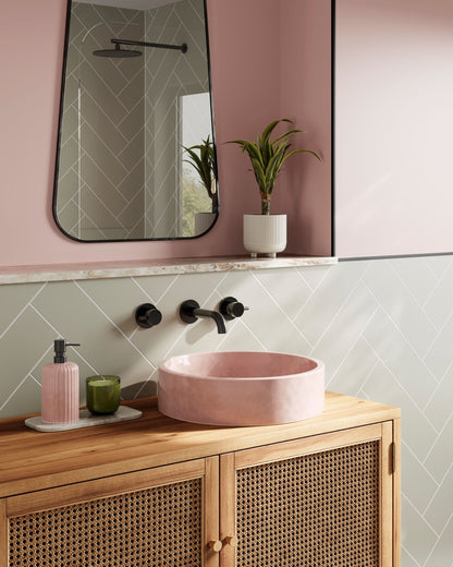 Multipanel Sage Green Herringbone shower panels on display in a bathroom, with a close-up photo showing a pink sink and matching pink soap bottle, complementing the pink wall panels. There are green wall panels below the pink ones, making the shower panels the main focus - shower panels - The Wall Works  