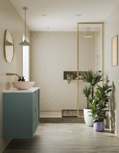 Multipanel Taupe Grey Herringbone shower panels on display in a bathroom with a cutout for a plant and shower necessities. It has a blue bathroom cabinet connected to the wall on the left with a pink aink on top of it. There are plants to the right with the gold shower door on display, matching the wall panels - shower panels - The 
Wall Works